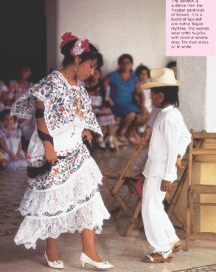 photograph of a woman and young boy dancing in traditional Mexican costume