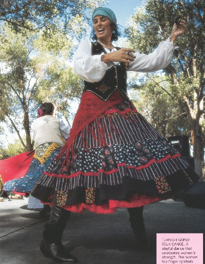 photograph of a woman dancing in traditional gypsy dress