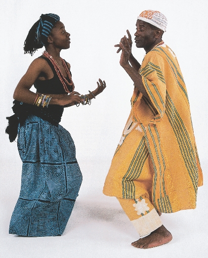 photograph of an African man and woman dancing together in traditional clothing