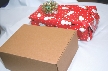 Photograph of two boxes—one with designed wrapping paper, the other with no paper