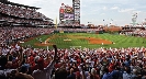 Photograph of a crowd cheering at a baseball game.