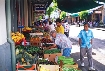 Photograph of people at an outdoor market.