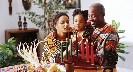 Photograph of a family lighting Kwanzaa candles.
