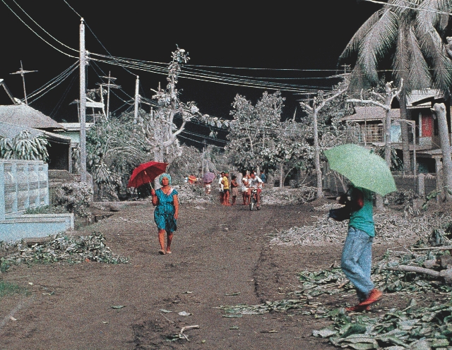 People in this village in the Philippines used umbrellas to protect themselves from ash. Nearby, Mount Pinatubo was erupting. Ash from the volcano darkened the sky.