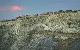 The wavy pattern of rock and soil here shows that the Earth has moved over time.