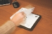 Photograph of a hand turning the page of a desk calendar