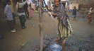 Photograph of a girl cranking the handle of a hand pump to get water