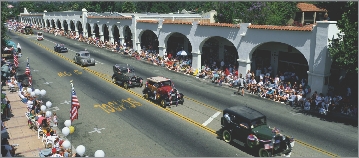 The cars move slowly down the street.