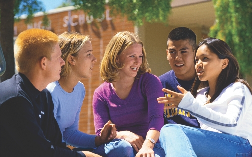 Photograph of a small group of high school students talking