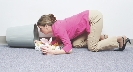 Photograph of a young woman on floor searching through a waste basket