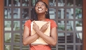 Photograph of a teenage girl with fingers crossed on both hands