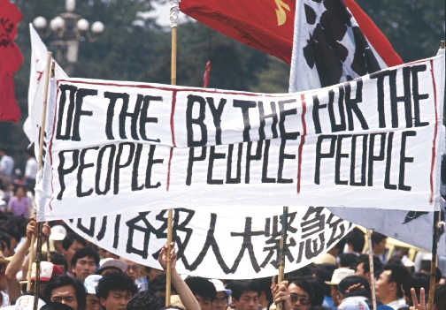 Students in Tiananmen Square carried signs asking for fair laws.