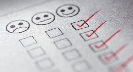 Photograph of a sheet of paper showing smiley faces checked off