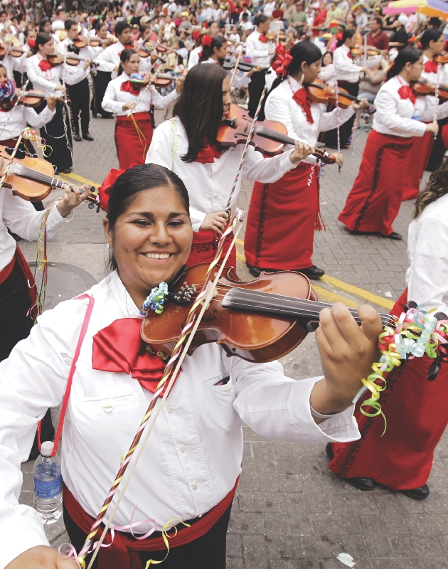 Photograph of people playing instruments in a marching mariachi band